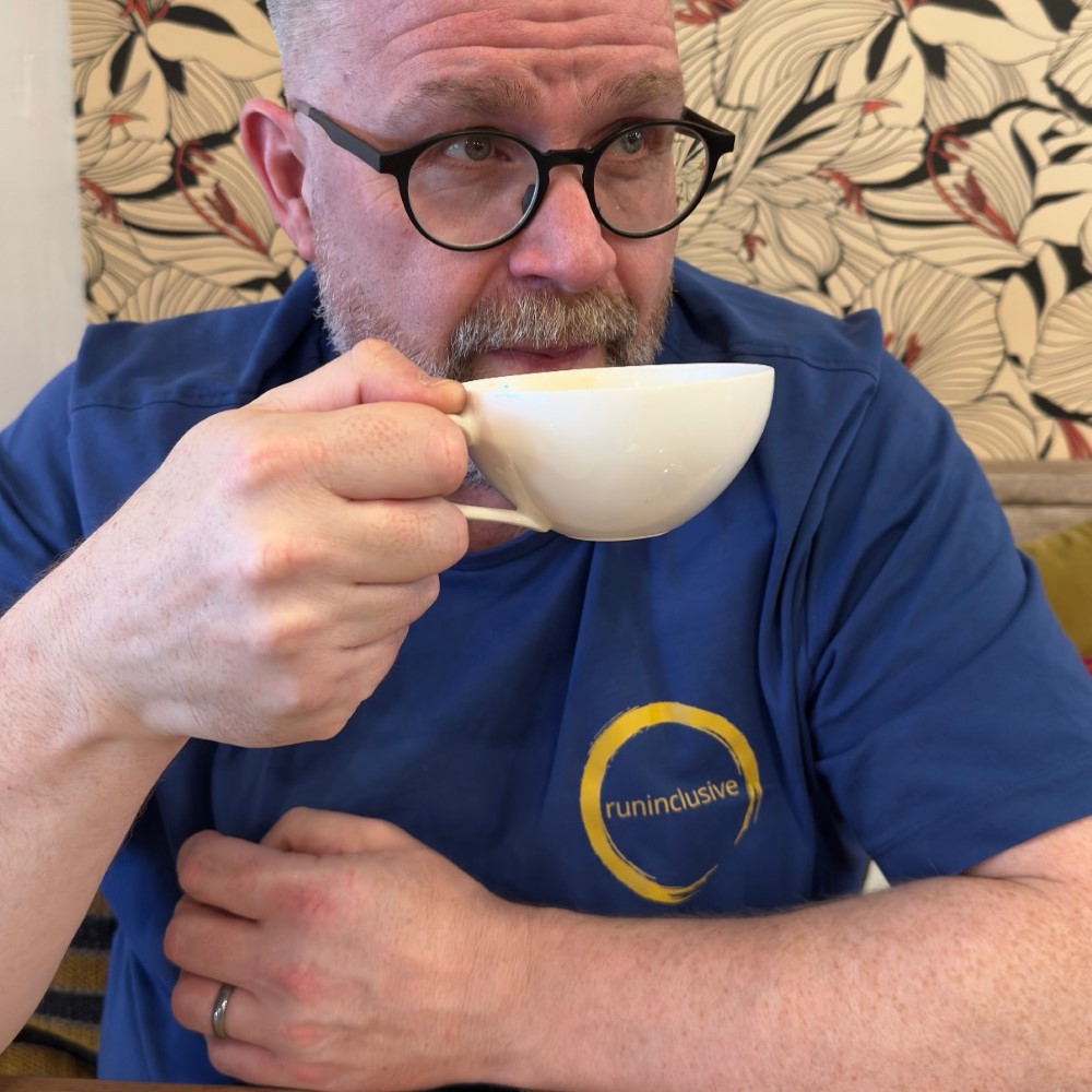 Andrew wearing the cotton DEI tee with the runinclusive logo on the chest