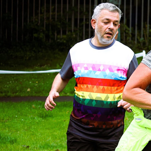 Huseyin wearing the Pride Geometric t-shirt at Parc Coed Gwilym parkrun