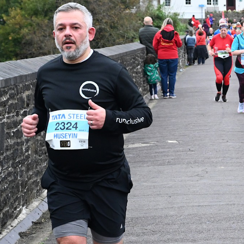 Huseyin wearing a Jet Black/ white long sleeved tee at the Richard Burton 10K 2024